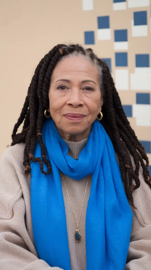 older Black woman with soft textured Marley twists and a blue scarf