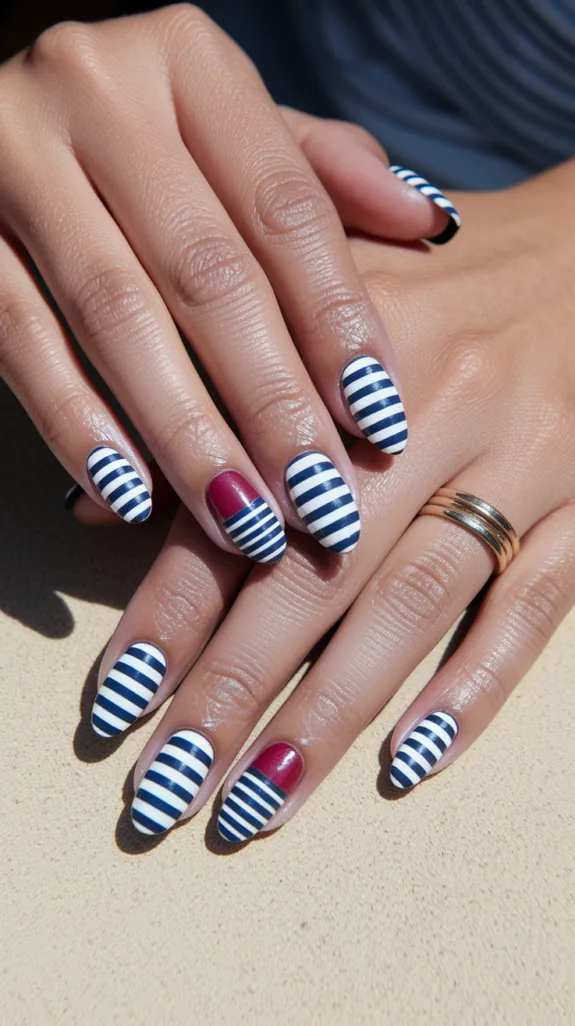 navy and white striped nails with one red accent nail